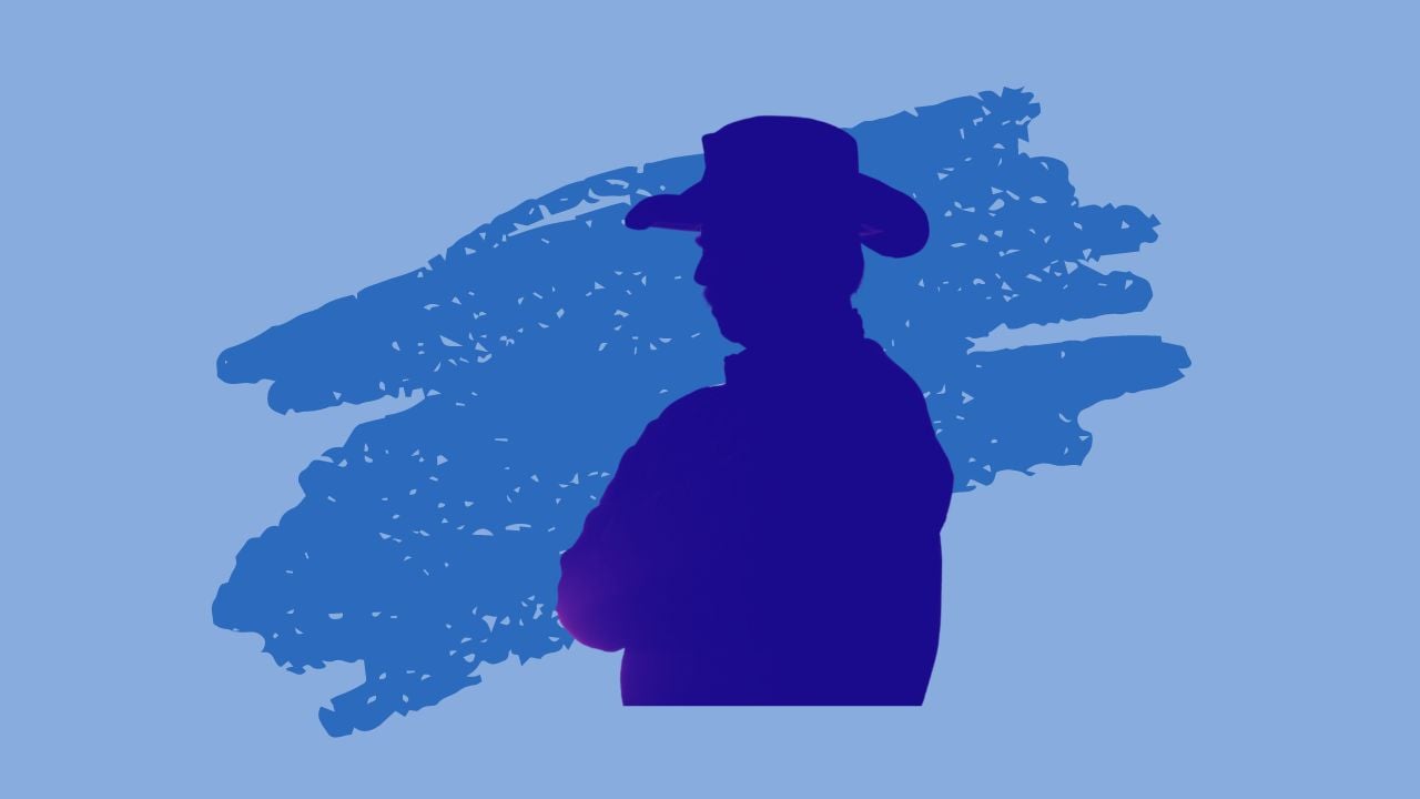 A silhouette of a man in a cowboy hat against a blue background. Who's career was better, George Strait or Garth Brooks?