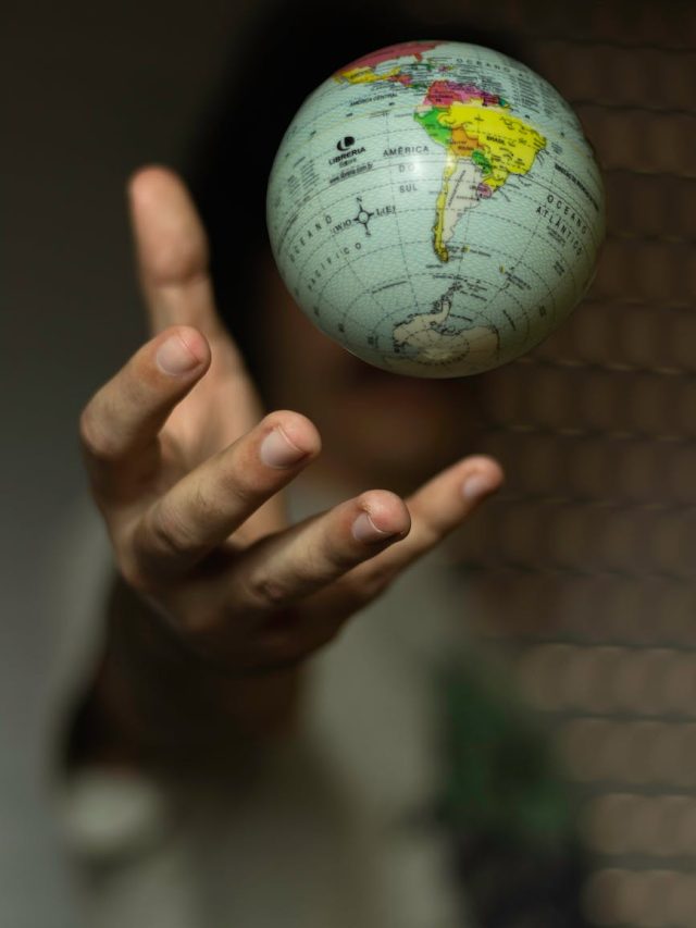 selective focus photo of globe floating over a hand
