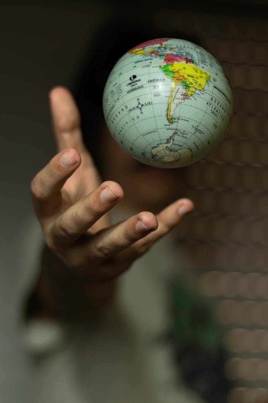 selective focus photo of globe floating over a hand