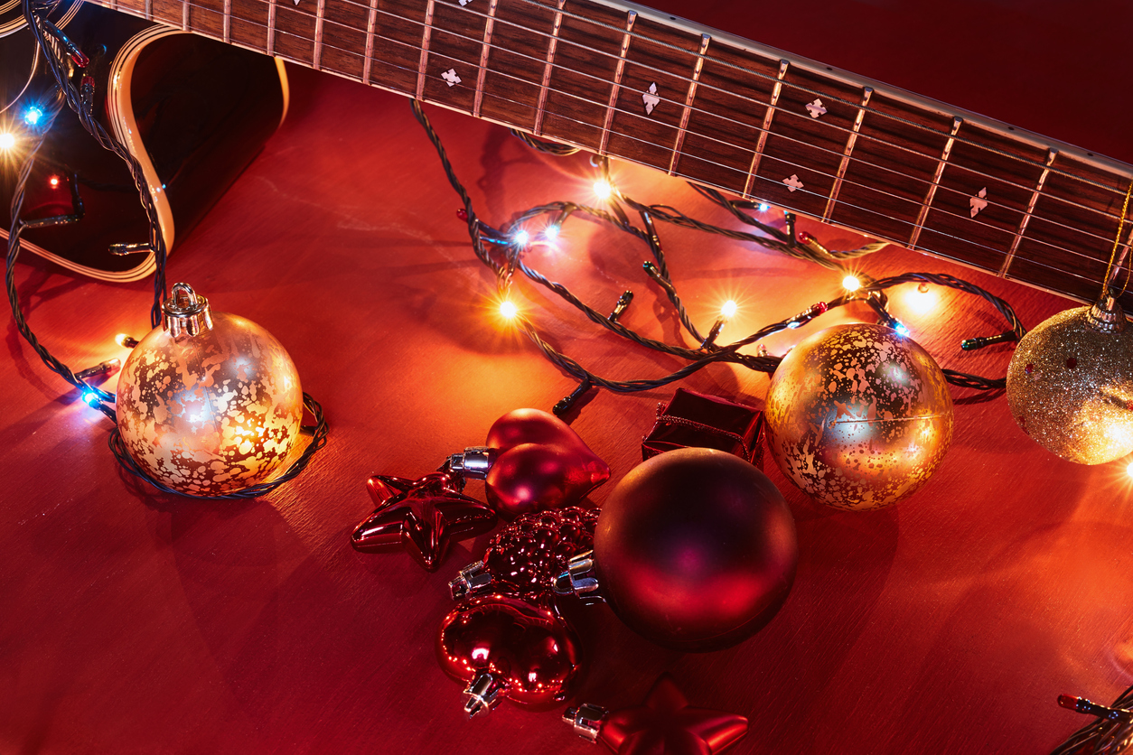 Christmas ornaments on a guitar representing country Christmas songs